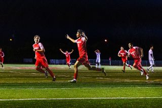 Edwin “Isiai” Ceuvas-Geroge runs toward the home supporters section at Wortman Stadium on Thursday, Sept. 18 after scoring the Grizzlies third goal in a match against Beaverton. Isiai said the team fed off energy created by Jovanni Olmedo’s first varsity goal to put Mac up 2-0.##Nathan Ecker/News-Register