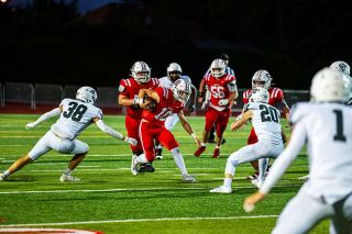 Drew Bizon scrambles through the West Salem secondary. He ran the ball eight times, but ended the game with negative rushing totals. He was, however, able to sling the ball up the field in the second half and threw for 149 yards on 35 pass attempts.##Rusty Rae/News-Register