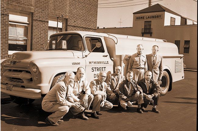 (Sept. 26, 1955) New addition to McMinnville street department line of equipment is this badly-needed street flusher, delivery of which was made late last week. Members of the city administration gathered to take a look at the 1500 gallon pumper which was purchased at cost of $6,614.25. Kneeling, left to right, City Attorney Eugene Marsh, Councilman F.O. Garrigus, Mayor Loyd Crow, Councilman Harold Taylor, Street Commissioner Ray Kidd, Councilman Walter Wagner. Standing at rear, City Recorder William A. Zosel and Councilman Delton Russell.