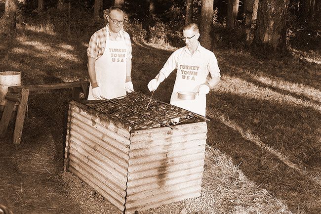 (Sept. 20, 1960) Readying turkey for a dinner last week between county turkey growers and the McMinnville retail committee were Louie Gross, county extension agent, (left), and A.C. Camp, president of county turkey growers. The 1960 turkey show, slated for November, was discussed by the groups.