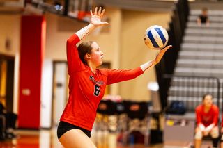 Junior setter Shannon Shaver pushes the ball into the air on a serve attempt in the Grizzlies match against Forest Grove on Wednesday, Sept. 24 in the MHS gymnasium. Shaver recorded a number of aces and assists in the match.##Rachel Thompson/News-Register