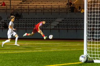 Edwin “Isiai” Cuevas-George strikes the ball toward Lincoln’s net for his first goal of the night against the Lincoln Cardinals on Thursday, Sept. 25. He scored twice in three minutes to give Mac a 3-0 lead at Wortman Stadium.##Nathan Ecker/News-Register