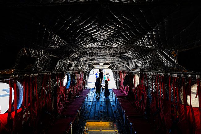 Rachel Thompson/News-Register##Visitors explore the cavernous interior of a CH-47F Chinook helicopter during the Oregon International Air Show on Friday. Operated by the Oregon Army National Guard, the aircraft can carry up to 30 combat-equipped soldiers and has supported relief missions from Hurricane Katrina to wildfires and floods across Oregon.