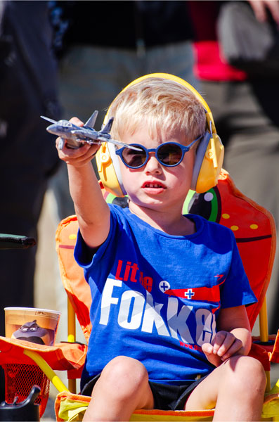 Rachel Thompson/News-Register##Felix Stevens, 4, of Corvallis, plays pilot with a toy jet as aircraft roar overhead during Friday’s Oregon International Air Show in McMinnville.