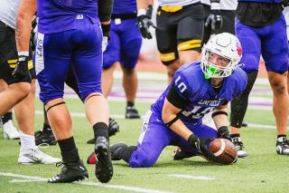 Junior Deacon Edgar jumps on a potential fumble during Linfield’s week one matchup against UW-Oshkosh on Sept. 6. Edgar found more reps in his new position due to injuries on the defensive side of the football.##Rusty Rae/News-Register file photo Junior Deacon Edgar jumps on a potential fumble during Linfield’s week one matchup against UW-Oshkosh on Sept. 6. Edgar found more reps in his new position due to injuries on the defensive side of the football.##Rusty Rae/News-Register file photo