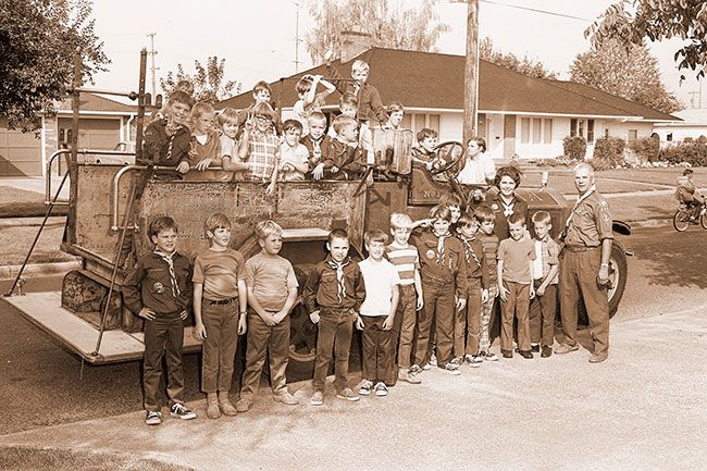 ##(Oct. 3, 1970) Pi Kappa Alpha fraternity from Linfield College each year provides rides in its fire engine to Cub Scouts from Pack 527 sponsored by Adams School to start the scouts’ year. Youngsters are shown with Warren Mueller, cubmaster, prior to riding truck around the area.