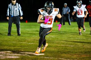 Yamhill Carlton senior running back Tyler Pond powers over the grass at Willamina High School’s football field en route to a touchdown. Pond scored twice against Willamina in the intercounty rivalry game on Friday, Oct. 3.##Rusty Rae/News-Register Yamhill Carlton senior running back Tyler Pond powers over the grass at Willamina High School’s football field en route to a touchdown. Pond scored twice against Willamina in the intercounty rivalry game on Friday, Oct. 3.##Rusty Rae/News-Register
