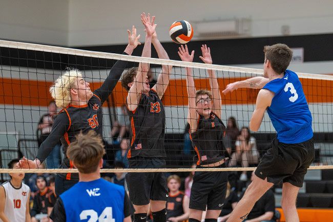 Rusty Rae/News-Register##Left to right, seniors Quintin McAvoy and Trey Jordahl and freshmen Ethan Harris jump in tandem to defend against a Western Christian spike during Yamhill-Carlton’s home match on Wednesday, April 2. McAvoy convinced the school to launch a boys volleyball team. The sport was sanctioned as an official OSAA activity on Monday, Oct. 6.