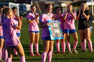Nathan Ecker/News-Register##Eliza Nisly holds up a gifted sign reading “100 CAREER GOALS” in celebration of her achievement after the Warriors victory over YC on Oct. 14 at Amity High School. She was greeted with hugs from nearly the entire community as they poured out their support. Nathan Ecker/News-Register##Eliza Nisly holds up a gifted sign reading “100 CAREER GOALS” in celebration of her achievement after the Warriors victory over YC on Oct. 14 at Amity High School. She was greeted with hugs from nearly the entire community as they poured out their support.