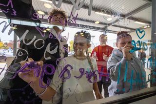 Rachel Thompson/News-Register##Seen from inside the cafeteria at McMinnville High School, Sources of Strength students write messages of hope and caring on windows on Oct. 8. They include, from left, Peyton Middleton, Jocelyn Middleton, Abigail Walters and King Sherbino. They and other SOS students and club members also have been spreading positive messages on windows within the school and on bathroom mirrors. Rachel Thompson/News-Register##Seen from inside the cafeteria at McMinnville High School, Sources of Strength students write messages of hope and caring on windows on Oct. 8. They include, from left, Peyton Middleton, Jocelyn Middleton, Abigail Walters and King Sherbino. They and other SOS students and club members also have been spreading positive messages on windows within the school and on bathroom mirrors.