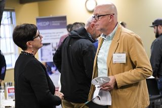 Rusty Rae/The News-Register##Caron Benner, right, owner of Cellar Ridge Construction, talks with McMinnville Mayor Kim Morris after Benner received the MEDP s Leader of the Year honor.