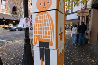 Rachel Thompson/News-Register##Set designer Alexis Yelonek created a wooden creation that lets passersby “Choose-Your-Own-Scarecrow.” It is located in front of Serendipity Ice Cream.