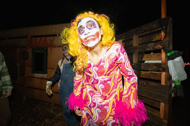 Rachel Thompson/News-Register##Lucas Partin, a senior at Yamhill Carlton High School, greets guests with a wide-eyed stare during the first weekend of the Haunted Maze in Carlton. Dressed in a psychedelic costume and yellow wig, Partin said his inspiration was “a vibe of Gladys from the movie ‘Weapons.’” “We’ve had one ‘pineapple,’” said sixth-grader Meya Thompson, referring to the safe word guests can shout if the scares get too intense. Admission is $5, with all proceeds supporting Yamhill Carlton Together Cares and its mission to empower and strengthen the community. Rachel Thompson/News-Register##Lucas Partin, a senior at Yamhill Carlton High School, greets guests with a wide-eyed stare during the first weekend of the Haunted Maze in Carlton. Dressed in a psychedelic costume and yellow wig, Partin said his inspiration was “a vibe of Gladys from the movie ‘Weapons.’” “We’ve had one ‘pineapple,’” said sixth-grader Meya Thompson, referring to the safe word guests can shout if the scares get too intense. Admission is $5, with all proceeds supporting Yamhill Carlton Together Cares and its mission to empower and strengthen the community.