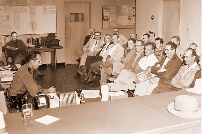 ##(Oct. 29, 1955) Ready for the tricksters, members of the Yamhill County Sheriff’s posse learn of duties and patrol schedules during briefing session conducted by Sheriff W. J. Jones (seated, left). Posse will join with other Yamhill county law enforcement bodies in tight patrolling of entire county Monday night to prevent malicious mischief, vandalism. Law enforcement officials are particularly concerned with any attempt to block streets and highways with barricades, pointing out such acts might cause a serious wreck. ##(Oct. 29, 1955) Ready for the tricksters, members of the Yamhill County Sheriff’s posse learn of duties and patrol schedules during briefing session conducted by Sheriff W. J. Jones (seated, left). Posse will join with other Yamhill county law enforcement bodies in tight patrolling of entire county Monday night to prevent malicious mischief, vandalism. Law enforcement officials are particularly concerned with any attempt to block streets and highways with barricades, pointing out such acts might cause a serious wreck.