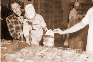 ##(Oct. 26, 1955) Tasty Treat for the kiddies at Archway Cookie Co. drew Sally and Eddie Sauter, shown with mother, Mrs. Verl Sauter, during Operation See It Yourself. Tour of ten industrial plants in McMinnville drew scores of spectators, despite gusty, cold day. ##(Oct. 26, 1955) Tasty Treat for the kiddies at Archway Cookie Co. drew Sally and Eddie Sauter, shown with mother, Mrs. Verl Sauter, during Operation See It Yourself. Tour of ten industrial plants in McMinnville drew scores of spectators, despite gusty, cold day.