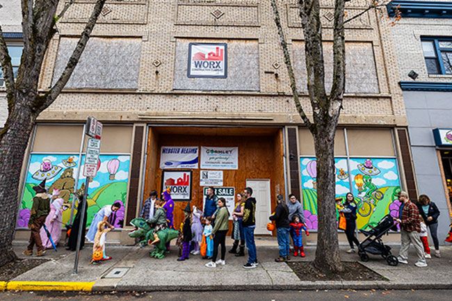 Rachel Thompson/News-Register##The 3rd Street Pizza building, seen during the trick-or-treating event on Halloween, is for sale for $950,000. The space has been empty since a May 2023 fire, but extensive renovation work has been completed.