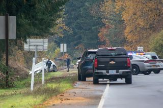 Ossie Bladine/News-Register##Law enforcement investigate the scene on Highway 18 in McMinnville Tuesday following a pursuit involving reports of shots fired at police vehicles. The Oregon State Police said Justice Allen Cochran, 24, of Salem and an unidentified 17-year-old were in the white car shown here when it rammed a Yamhill County Sheriff’s Office vehicle, and the two suspects fled on foot after the crash. Once they were apprehended, the highway remained closed into the evening for investigation.