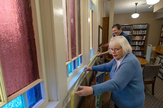 Rachel Thompson/News-Register##Mary McBride and Colin Cameron measure the colored glass windows in the library of the McMinnville First Presbyterian Church. They were Installed almost 130 years ago.
