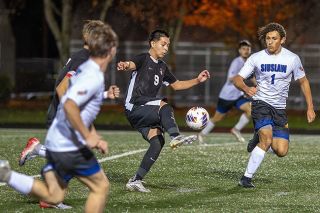 Rachel Thompson/News-Register##Junior Gerardo Garcia works the ball up field and between Siuslaw defenders during Dayton’s 2-0 home victory at “Coach” Dewey Sullivan Stadium on Wednesday, Nov. 5. Garcia scored goal No. 2 with an assist from Alexander Garcia on a through ball.
