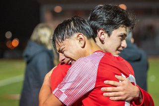 Rusty Rae/News-Register##Sophomore defender 	Adrian Villalobos hugs current McMinnville student and former high school player Abraham Romo after the Grizzlies’ 1-0 loss to Ida B. Wells at Wortman Stadium on Wednesday, Nov. 5.
