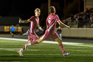 Rachel Thompson/News-Register##Pirates’ junior Riley Corona (No. 7) runs towards senior captain Johnathan Mendez (No. 6) with arms extended in celebration after Mendez tied Dayton’s quarterfinal game against Creswell at 1-1 on Saturday, Nov. 8, at Dayton High School.