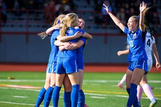 Rusty Rae/News-Register##Teammates surround Haley Miersma, celebrating after the senior forward scored her third goal of the game in Amity’s 6-1 quarterfinal victory over Brookings-Harbor at Wortman Stadium on Saturday, Nov. 8.