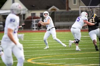 Rusty Rae/News-Register##Junior quarterback Luke McNabb eyes a receiver during Linfield’s 31-15 victory over Pacific Lutheran University on Oct. 25. In the ‘Cats Nov. 8 contest, he slung a single-game career high seven touchdowns.