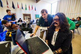 Rachel Thompson/News-Register##Steve Swartwood II of Sheridan, left, checks tournament logistics while Curt Rivadeneira of Dayton, right, serves as shoutcaster — a commentator — during Saturday’s West Valley Esports and Gaming Expo at Sheridan High School. Esports — short for electronic sports — refers to organized video game competitions.