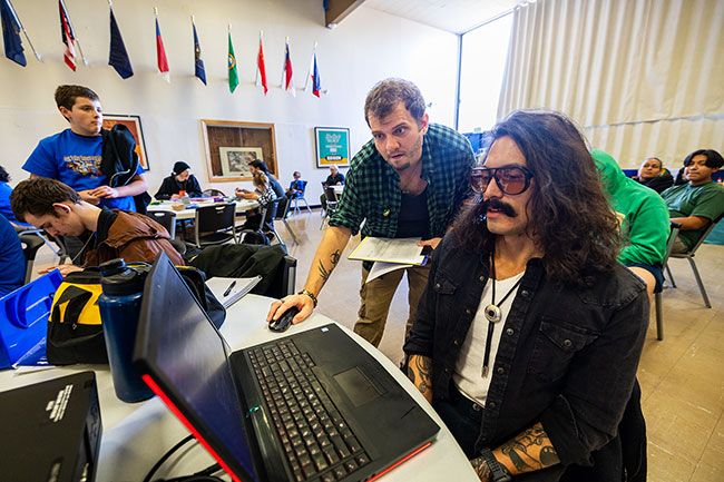 Rachel Thompson/News-Register##Steve Swartwood II of Sheridan, left, checks tournament logistics while Curt Rivadeneira of Dayton, right, serves as shoutcaster &mdash; a commentator &mdash; during Saturday&rsquo;s West Valley Esports and Gaming Expo at Sheridan High School. Esports &mdash; short for electronic sports &mdash; refers to organized video game competitions.