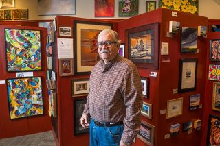 Rusty Rae/News-Register##Photographer Michael Anderson shows off a gallery of his artistic photos inside the John Stromme Art Gallery on Third Street. Anderson is donating proceeds from sales to the Court Appointed Special Advocates program, which helps children involved in the court system.