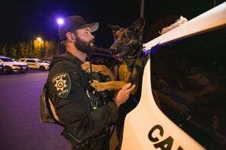 Rachel Thompson/News-Register##Yamhill County Sheriff’s Office Deputy Colton Waker greets his K-9 partner,  Valk  Valkyrie, during a nighttime training session at the county’s Public Works facility on Oct. 29. The two have worked together for five years and train weekly.