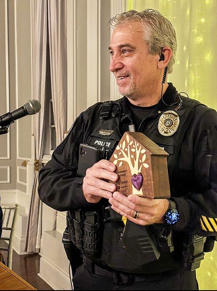 Submitted photo##Yamhill Police Chief Greg Graven accepts the Changing Hearts Impact Award from Juliette&rsquo;s House for his dedication to protecting children and supporting families in Yamhill County. He was one of several winners of the nonprofit child abuse intervention center&rsquo;s new Heart of the Community awards, given at an event Thursday. All the awards were handmade by woodworker Rolf Wuellner.