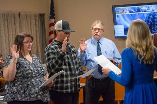 Emily Bonsant/News-Register## Yvonne Hamilton swears in Sheridan city staff members Monday. From left are Amber Mathiesen, assistant city manager and finance director; Kaihdan Trombla, code compliance officer and community services coordinator; and Preston Polasek, who is continuing to serve as city manager.