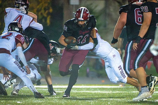 Rusty Rae/News-Register file photo##Stephan Macias escapes a tackle during Dayton&rsquo;s first-round playoff game against Douglas on Friday, Nov. 7 at Dayton High School. Macias ran for 51 yards and a touchdown, while securing 14 defensive tackles in what ended up as his final high school football game.