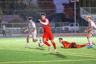 Nathan Ecker/News-Register file photo##Edwin “Isai” Cuevas-George makes Sunset defenders look silly en route to a goal during the Grizzlies’ 4-0 victory in the first round of the 6A State Championship tournament. Isai scored three goals in the contest, marking his fifth and final hat trick of the 2025 season.