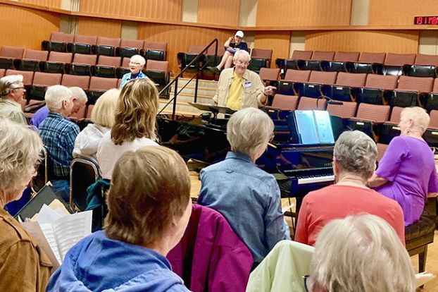 Submitted photo##John Buehler, a retired university music professor, conducts a rehearsal of the Yamhill Valley Community Chorus, which will make its debut Saturday, Nov. 22. Buehler and his wife, Susan, right, who plays piano for the chorus, moved to Oregon from Kansas and settled in Newberg in 2023. Chorus members are serious about music, Buehler said, but the rehearsals also include a lot of levity.