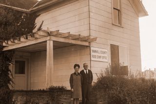 ##(Nov. 21, 1970) County Food Stamp office, located at 634 N. Ford, is now open for business and through Nov. 16 $40,784 worth of food stamps were issued to county residents who qualified for the assistance. This was 644 cases handled or 1904 individuals who received the stamps under the direction of Rex Haynie, supervisor of the stamp issuance. Shown with Haynie on steps of house is Helen Jackman, food stamp certification supervisor, who certifies low-income families.