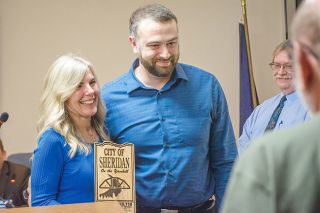Emily Bonsant/News-Register##Yvonne Hamilton receives Sheridan’s Excellence Award from Mayor Cale George at the Nov. 17 city council meeting. Hamilton, who retired this month, was honored for 24 years of service by councilors, staff and community members.