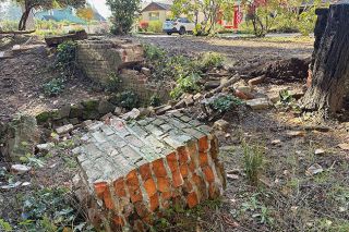 Racheal Winter/News-Register##In McMinnville City Park, a large section of a 24-foot historic wall rests on the ground after a single-car accident destroyed it.