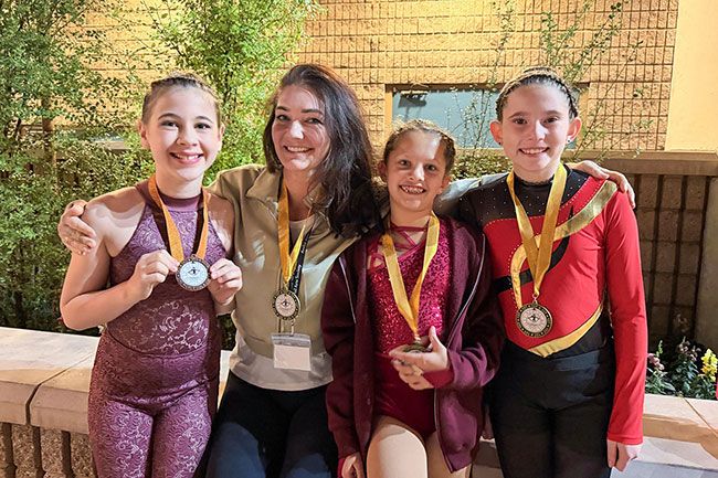 Submitted photo##Earth & Elevate instructor Jessie Tay, center, poses with members of the McMinnville aerial studio’s competitive team, including Natalie Kondor, left, Nisha Kumar and Holland Bertsch, right. The girls brought home medals from their first competition.