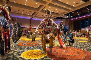 Rachel Thompson/News-Register##Dressed in full regalia, Nacoma Liebelt of Grand Ronde joins the circle during Saturday’s Grand Entry at the Grand Ronde Restoration Celebration Powwow at Spirit Mountain Casino. The event marked 42 years since the Tribe’s federal recognition was restored.