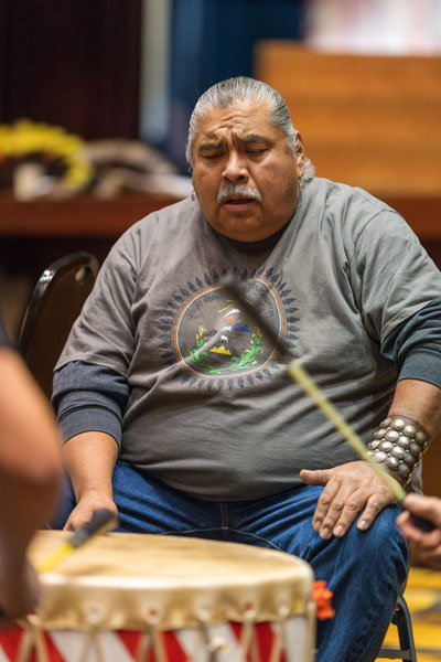 Rachel Thompson/News-Register##James Thinn of Portland, a member of the Turquoise Pride drum group, joins the Jóhonaa’éí drum group during the powwow. Drummers often step in with other groups when they know the song. Rachel Thompson/News-Register##James Thinn of Portland, a member of the Turquoise Pride drum group, joins the Jóhonaa’éí drum group during the powwow. Drummers often step in with other groups when they know the song.