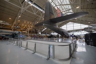 Rachel Thompson/News-Register##The Glide and Gather skating rink, which is made up of panels of synthetic ice, is set up under the tail of the Spruce Goose in the Evergreen Aviation Museum. Visitors can skate every weekend through the holiday season. They also can choose to tour the museum’s Goose Lights attraction, in which planes and helicopters are outlined with colored bulbs.