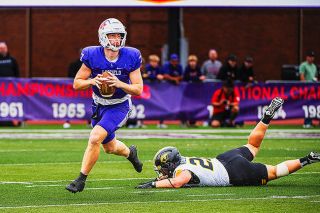 Rusty Rae/News-Register file photo##Luke McNabb scrambles away from pressure during the Wildcats Sept. 6, 2025 game against the University of Wisconsin-Oshkosh at Maxwell Field.