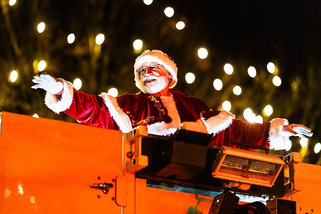 Rachel Thompson/News-Register##Santa waves from atop a McMinnville fire truck, drawing the loudest cheers of the night.