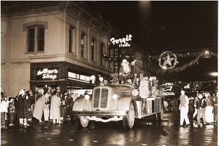 ##(Dec. 29, 1955) Hi Kiddies! — That was jolly Santa’s cry as he greeted a horde of youngsters during parade Monday night, officially opening McMinnville’s Christmas season. Youngsters and adults, alike, braved chill winds and downpour to greet Saint Nick during his triumphal entry into the city.