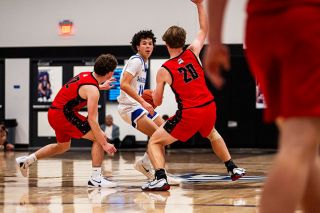 Rusty Rae/News-Register##Freshman guard Carter Haarsma looks upcourt as the Warriors get in position on offense. Haarsma was the team s leading scorer with 39 points during the Warrior Classic.