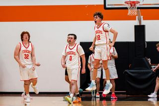 Rusty Rae/News-Register##Tigers’ sophomore guard Chase Wald (No. 12) jumps for joy after securing a victory at the Tiger Dome in double overtime on Friday, Dec. 5. Willamina tried to rebound and put back a purposeful missed free throw to tie at the end but was unsuccessful.