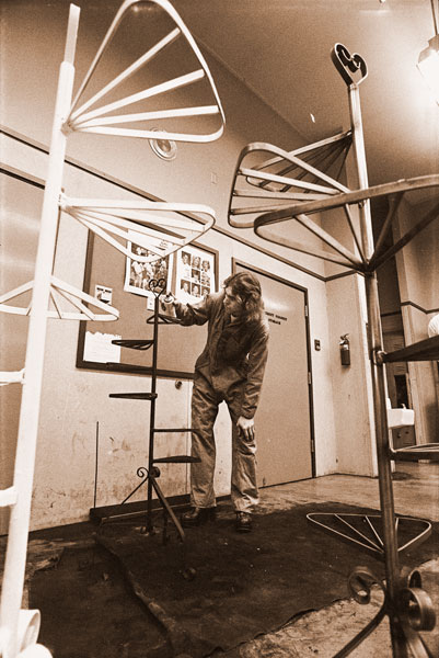 ##(Dec. 9, 1955) Members of VICA, Vocational Industrial Clubs of America, are making plant holders out of metal in order to meet club operational costs. Holders are available at school store. Here, club president Jon Wilder, a junior, puts finishing touches on project.