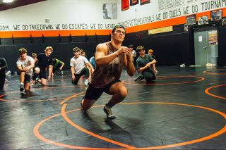 Emily Bonsant/News-Register##Junior wrestler Landon Risseeuw warms up with fellow Bulldog wrestlers. RIsseeuw took fifth at the 3A State Championship last year in the 190-weight class.
